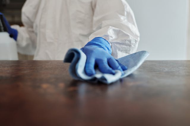 someone cleaning a table