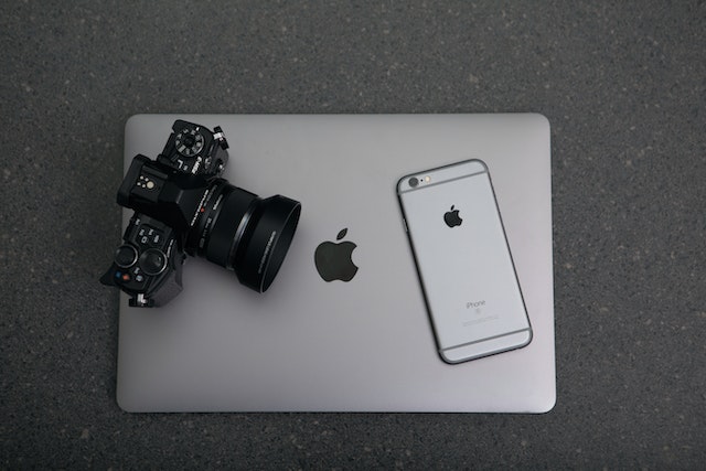 camera-and-cellphone-resting-on-top-of-a-closed-laptop