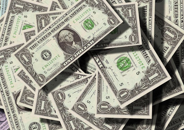 a-pile-of-us-one-dollar-bills-scattered-randomly